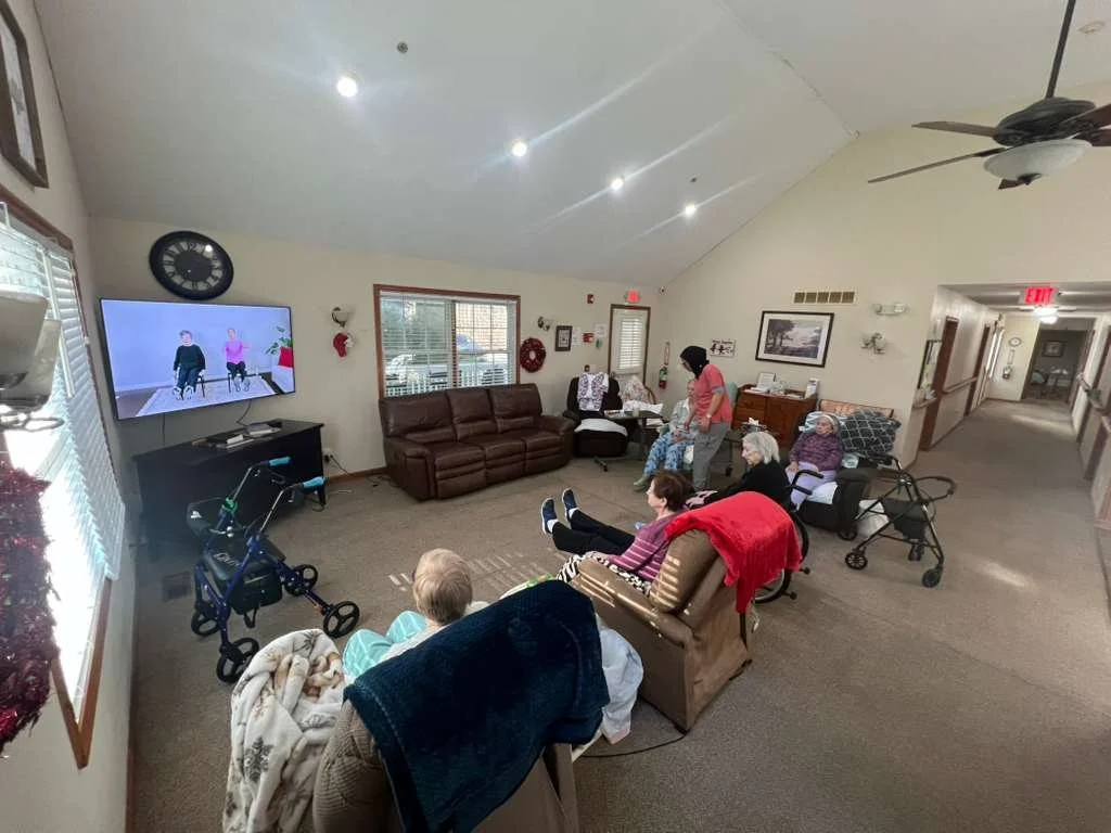 Residents engaging in a seated exercise activity in a common area