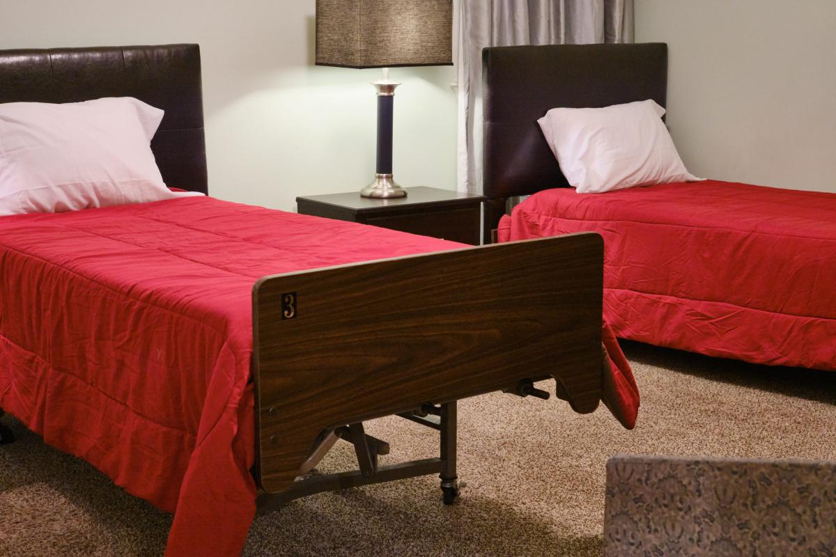 Two twin beds in a well-furnished resident room
