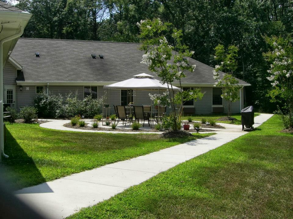 Outdoor area with seating and trees in a senior care community