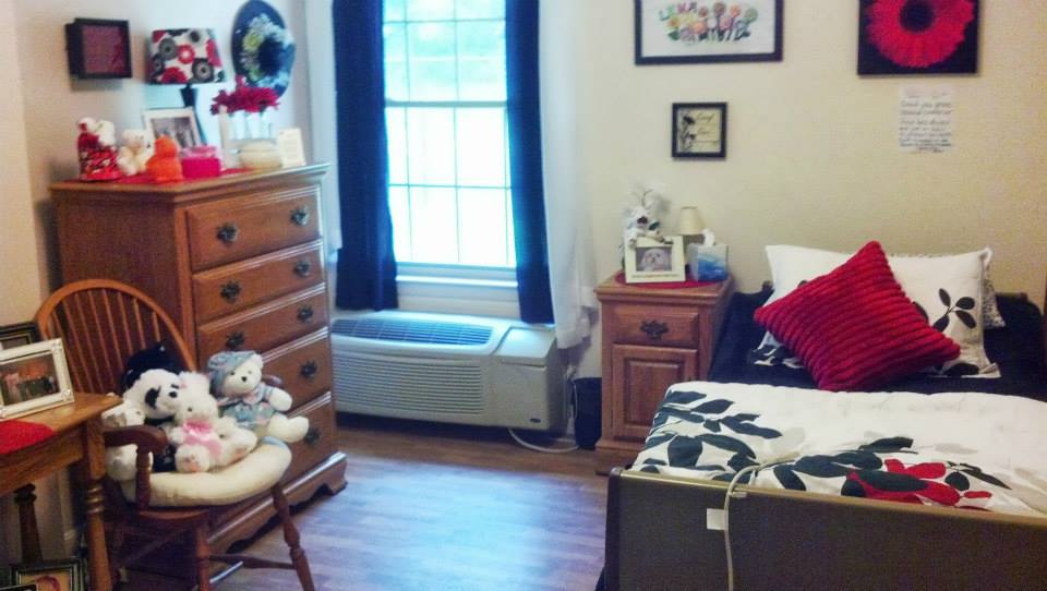 A cozy resident room with decorations and a bed