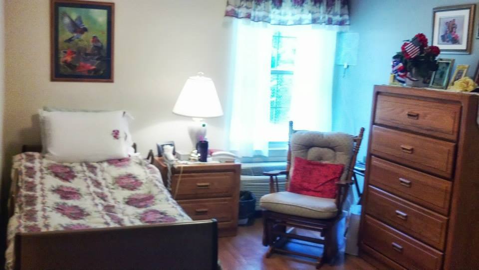 Cozy resident room with a bed and chair