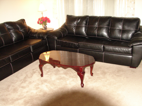 Comfortable black sofas in a common area