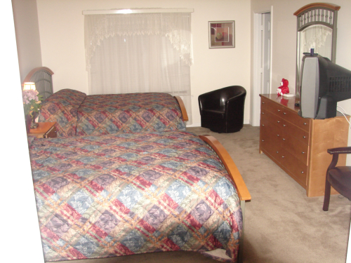 Cozy shared bedroom with two beds and furniture.