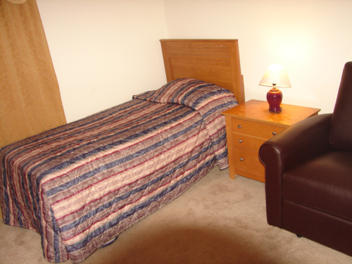 Cozy bedroom with a single bed and nightstand.