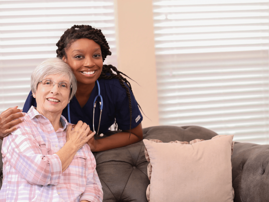 Nurse and elderly resident smiling together