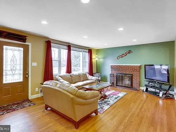Cozy living room with a fireplace and seating area.