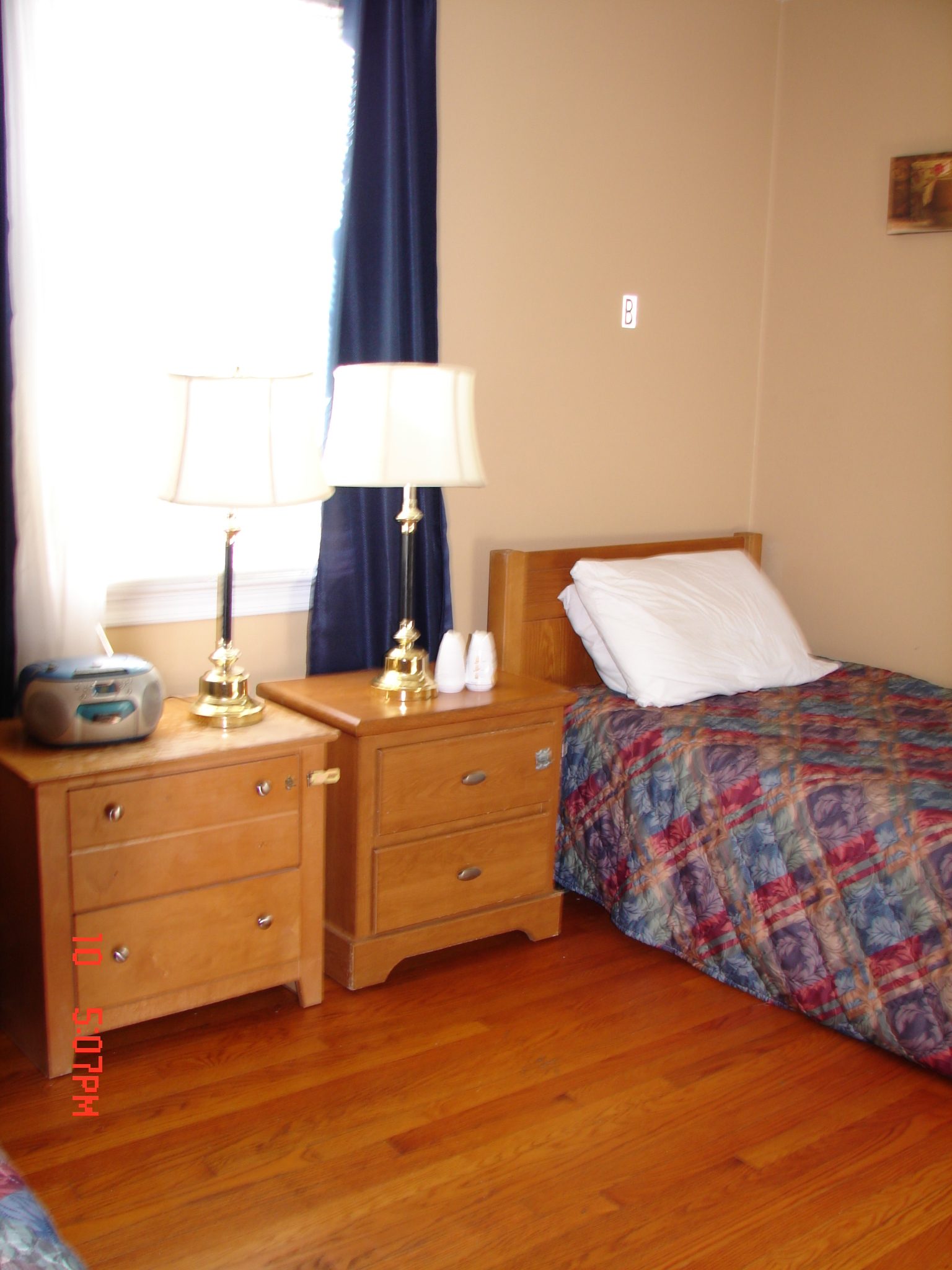 Cozy resident bedroom with two beds and lamps.