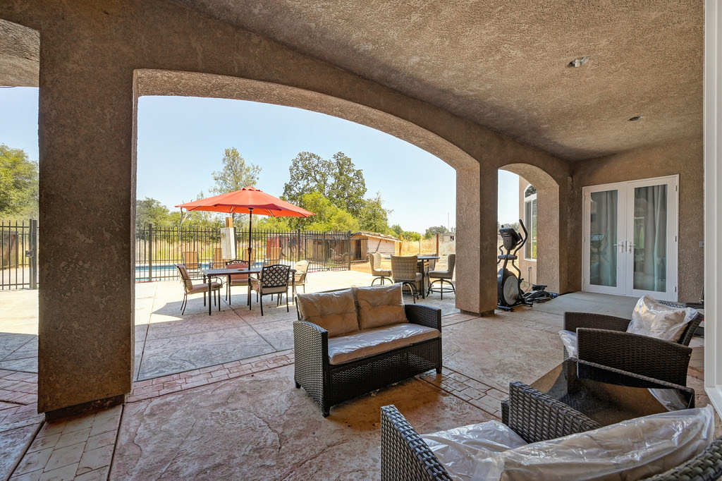 Outdoor patio with seating and pool view