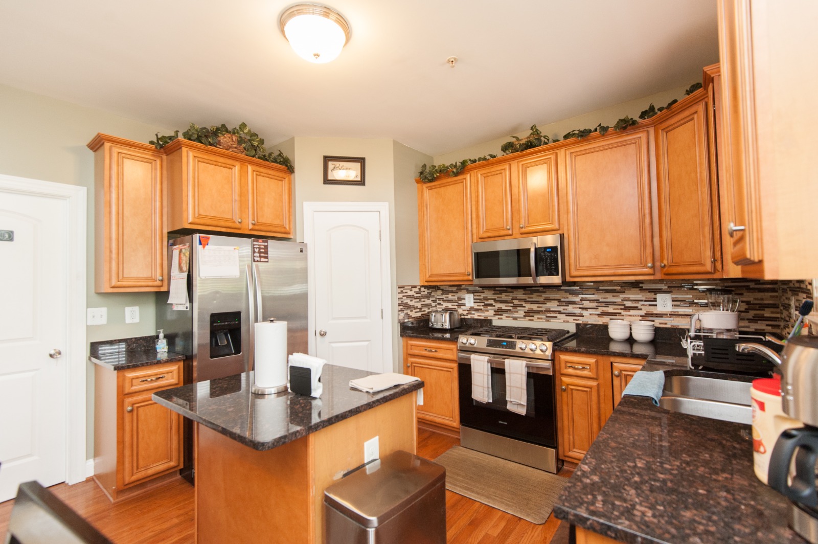 Bright kitchen area with wooden cabinets and modern appliances