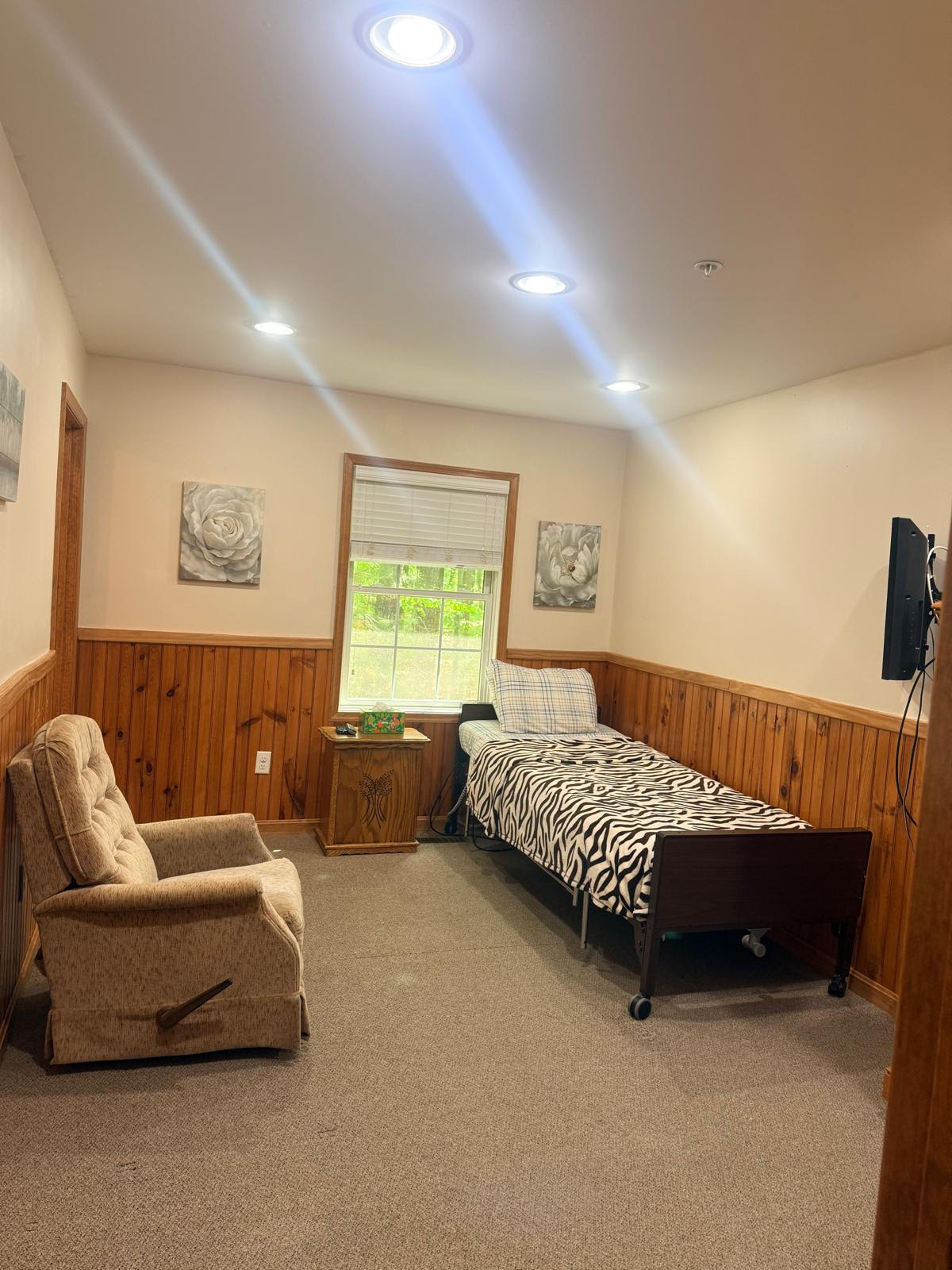 Private resident room with a bed and armchair