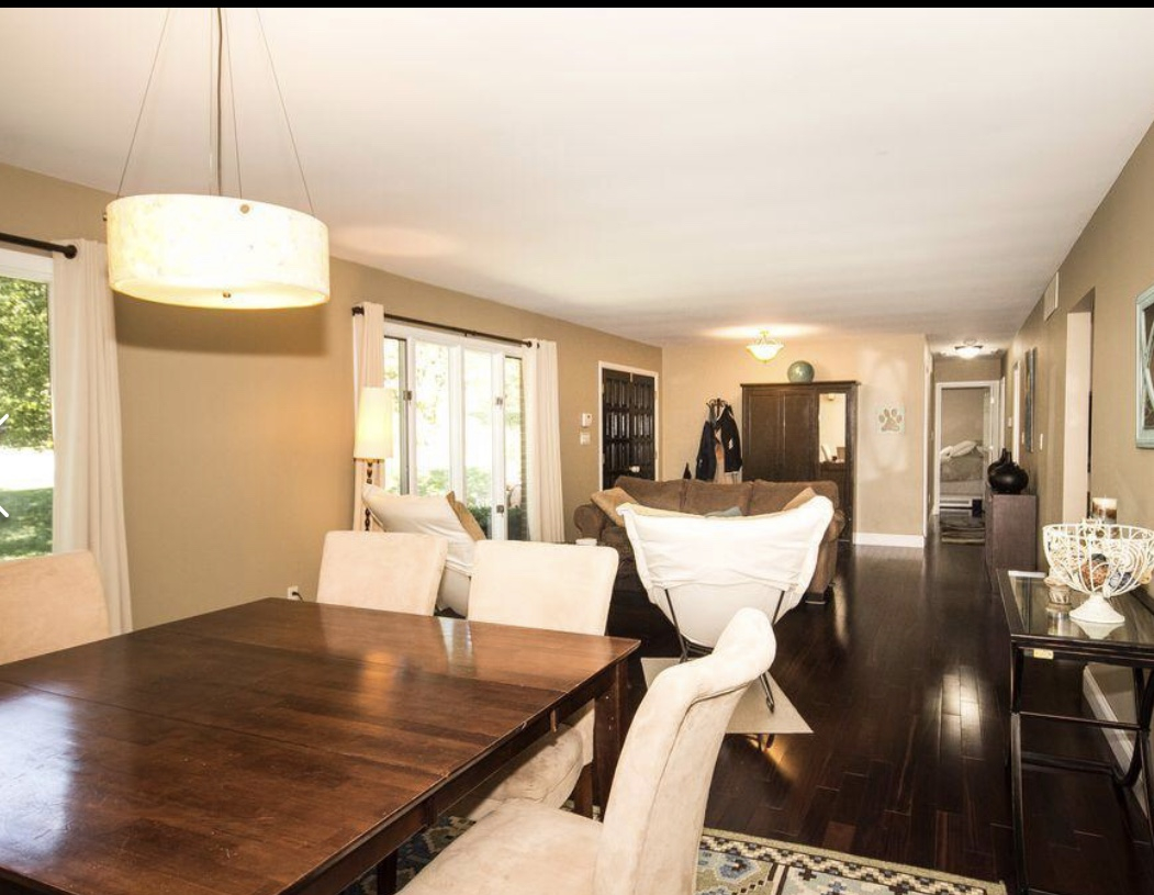 Bright common area with a dining table and seating