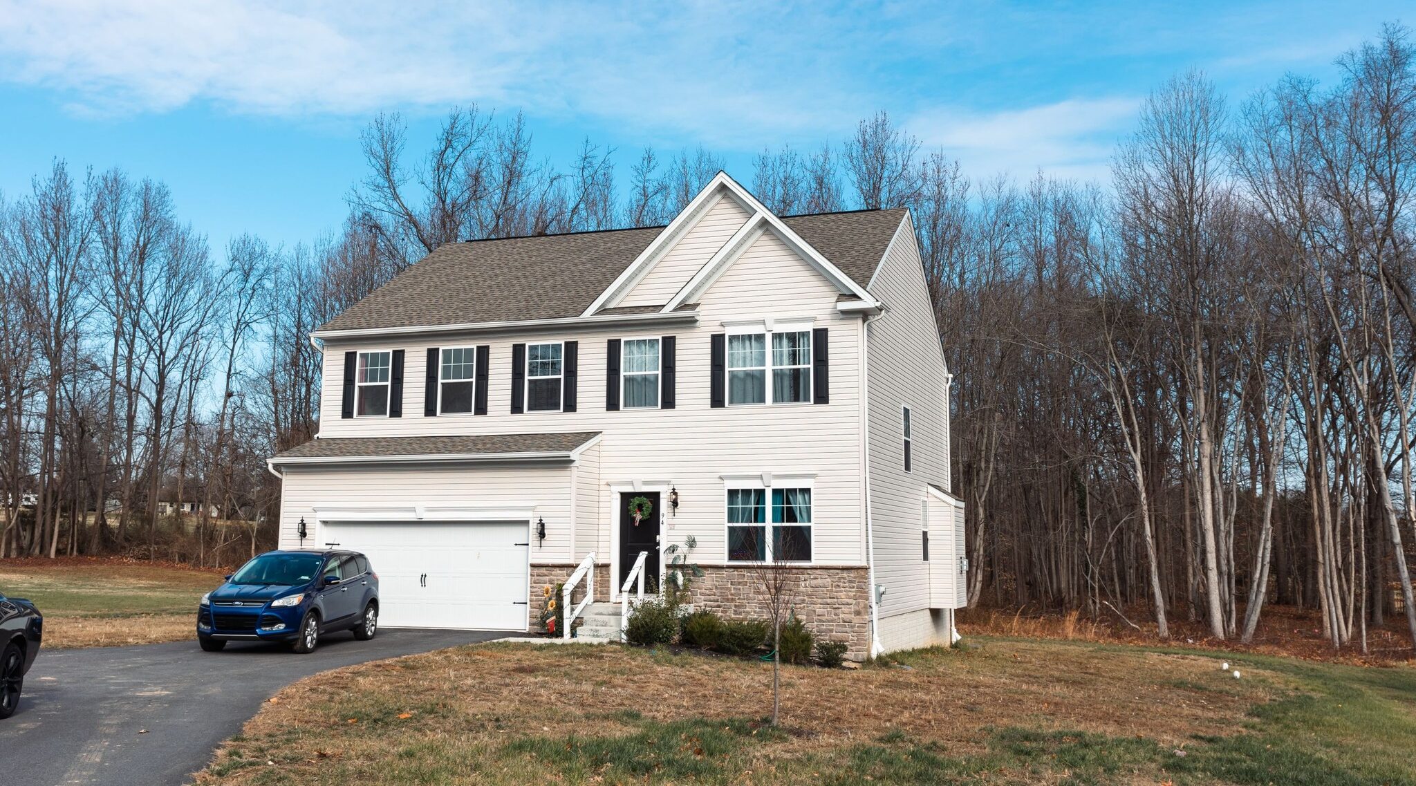 Front view of a residential building with vehicle