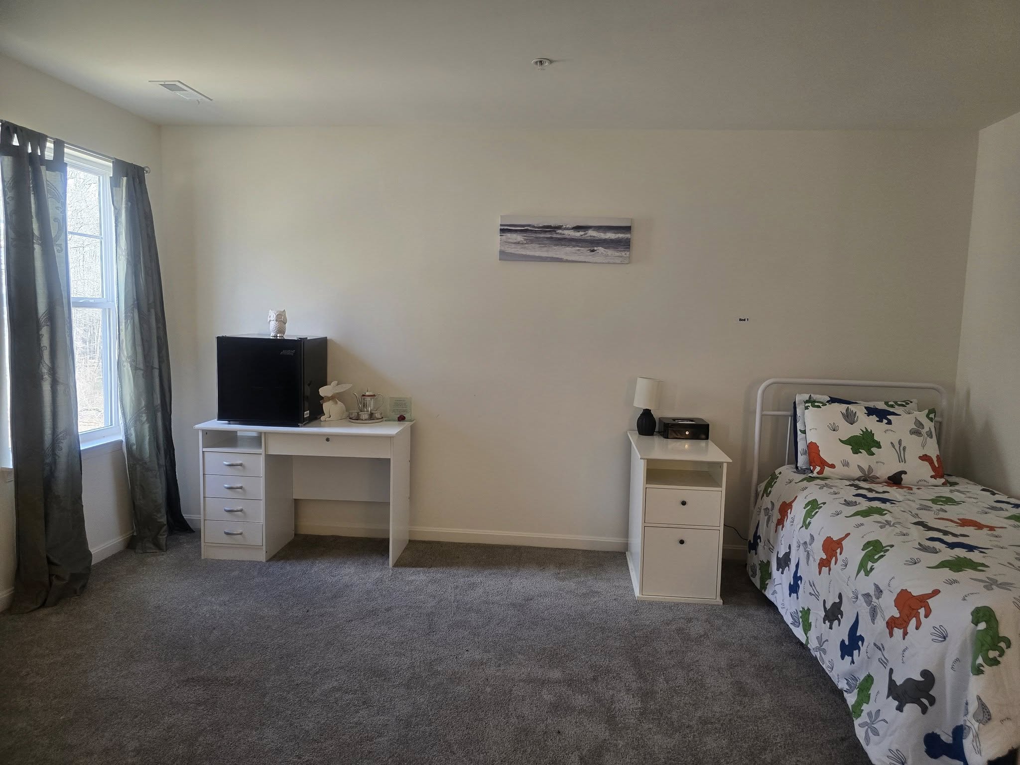 A private room with a single bed and furniture