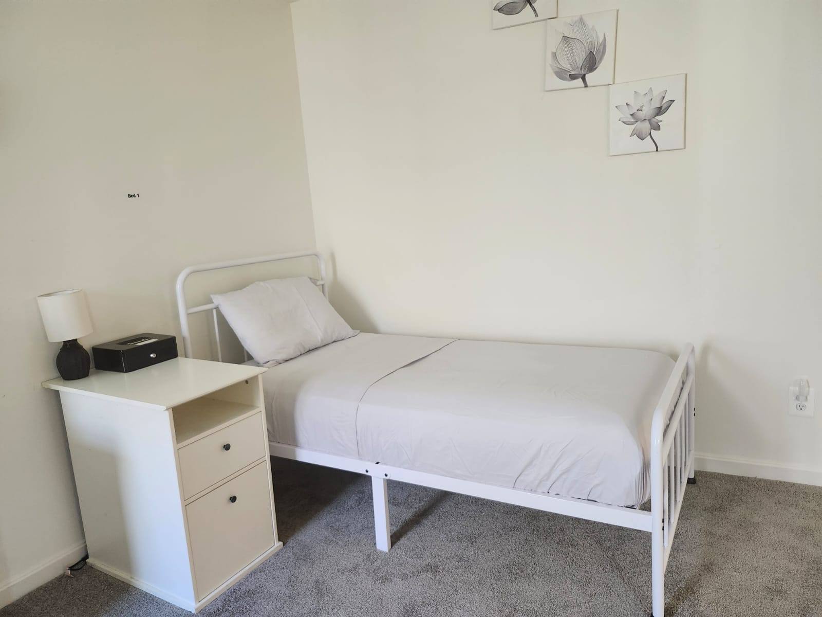 Cozy private room with a bed and bedside table