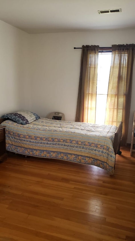 Cozy private resident room with a bed and window.