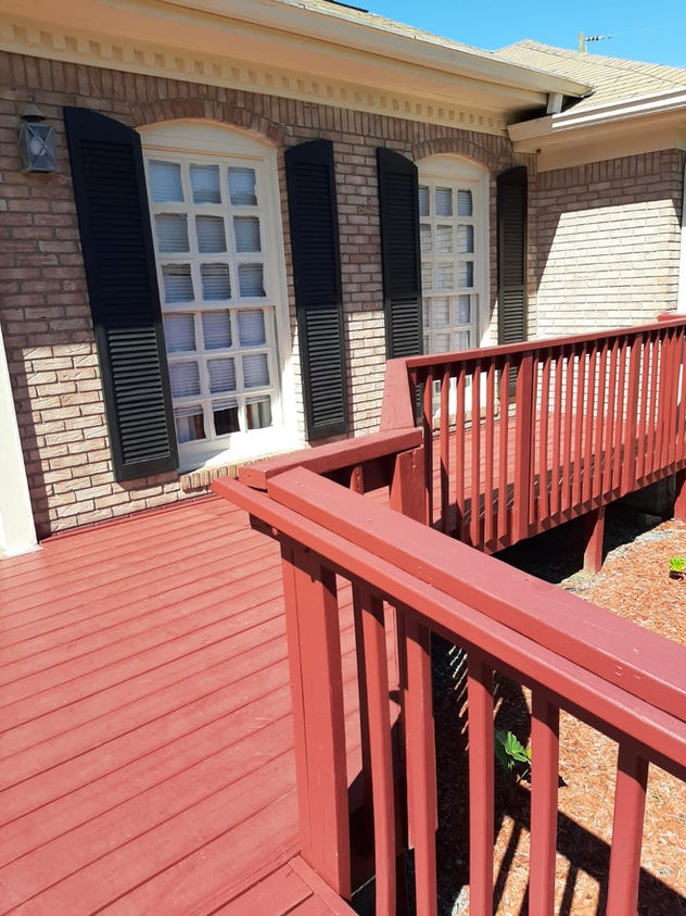 Outdoor deck area with railings and windows