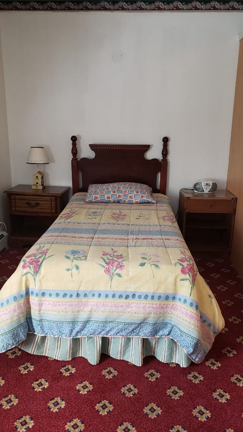 Cozy private resident room with floral bedding