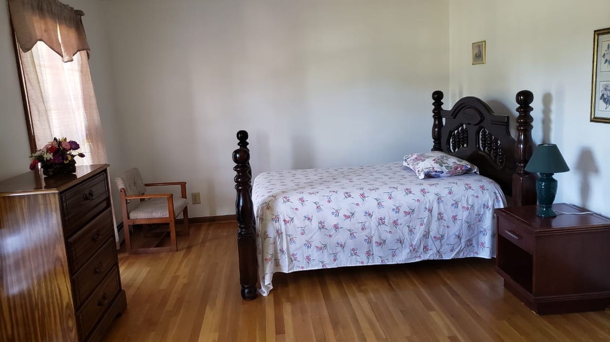 A cozy resident room with a bed and furniture.
